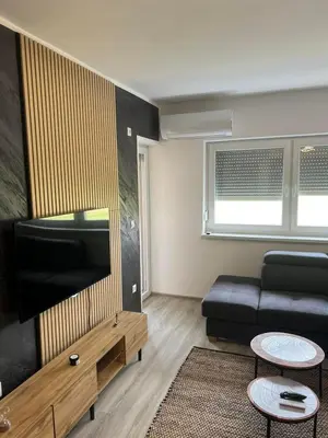 a living room with a couch and a flat screen tv at Una-No1 in Bihać