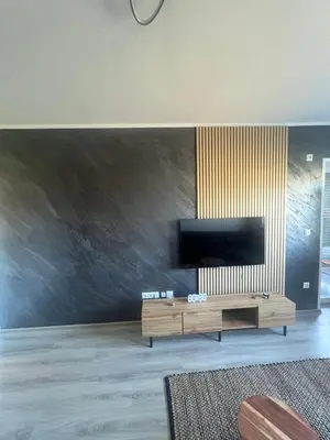 a living room with a flat screen tv on a wall at Una-No1 in Bihać