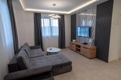 a living room with a couch and a tv at Hotel Sistems in Banja Luka