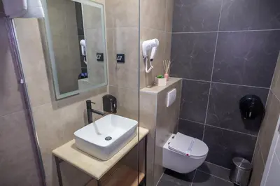 a bathroom with a sink and a toilet and a shower at Hotel Sistems in Banja Luka