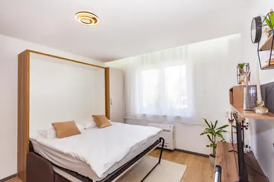 a bedroom with a bed and a window at Apartman Krželj A1 in Livno