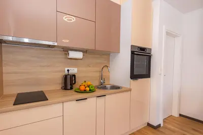 a kitchen with a sink and a bowl of fruit at Apartman Krželj A1 in Livno