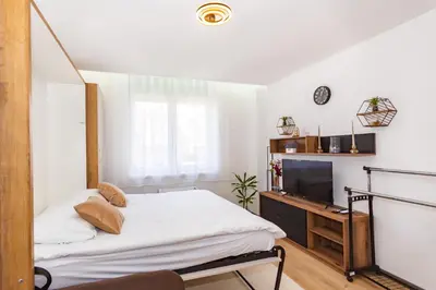 a small bedroom with a bed and a television at Apartman Krželj A1 in Livno