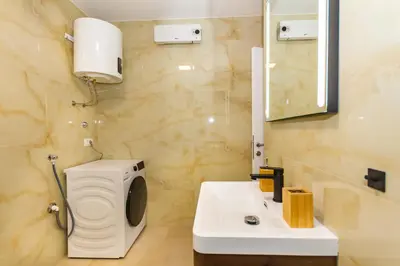 a bathroom with a toilet and a sink and a mirror at Apartman Krželj A1 in Livno