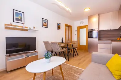 a living room with a couch and a table at Apartman Krželj A2 in Livno