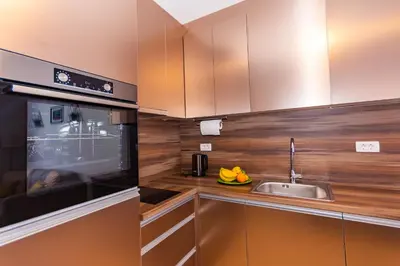 a kitchen with a sink and a microwave at Apartman Krželj A2 in Livno