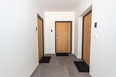 a hallway with two doors and a tile floor at Apartman Krželj A2 in Livno