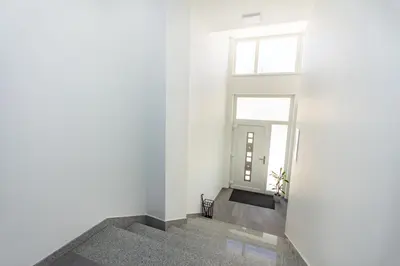 a hallway with white walls and a window at Apartman Krželj A2 in Livno