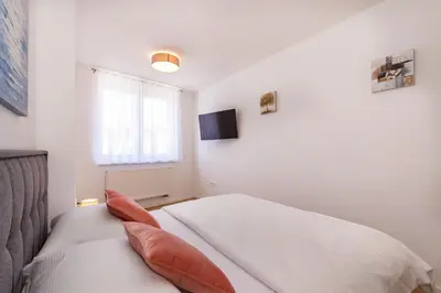 a bedroom with a bed with two pillows on it at Apartman Krželj A3 in Livno