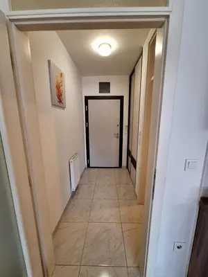 a hallway with a door and a tile floor at Apartman Sarah - Autobuska Stanica in Tuzla