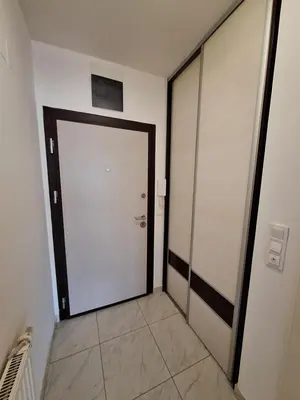 a corridor with a door in a building at Apartman Sarah - Autobuska Stanica in Tuzla