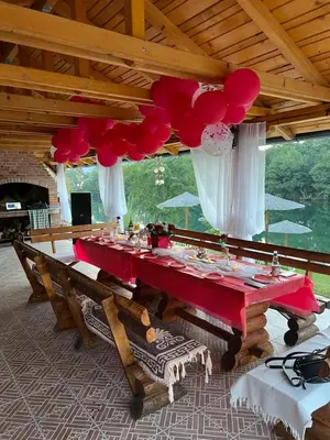 a long table with red and white decorations in a room at Una Relax in Bosanski Novi
