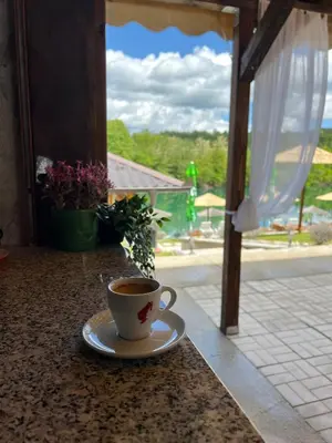 a cup of coffee sitting on a counter in a porch at Una Relax in Bosanski Novi
