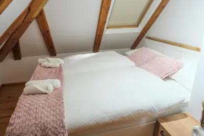 a bedroom with two beds in a attic at Apartman Maja in Jajce