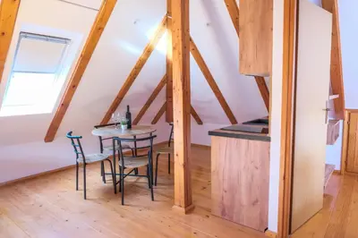 a kitchen and dining room with a table and chairs at Apartman Maja in Jajce