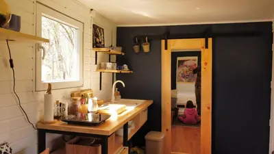 a kitchen with a counter and a sink and a window at Sole Tiny House in Šipovo
