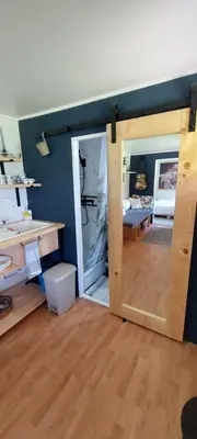 a room with a door open to a living room at Sole Tiny House in Šipovo
