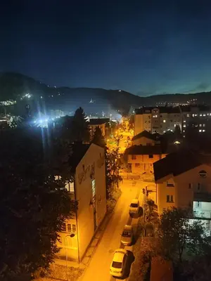 a city at night with cars parked on a street at Apartman 50 in Banja Luka