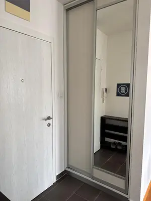 a mirrored door in a room with a mirror at Apartman 50 in Banja Luka