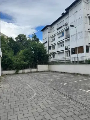 an empty parking lot in front of a building at Apartman 50 in Banja Luka