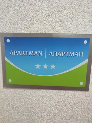 a sign on a wall that reads apartment istg istg at Apartman 50 in Banja Luka