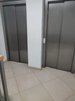 an empty locker room with two metal doors at Apartman 50 in Banja Luka