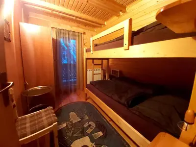 a bedroom with two bunk beds and a window at Holiday Home Tirol in Vlasic