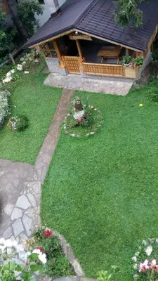 a garden with a gazebo in the background at Holiday Home Tirol in Vlasic