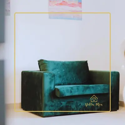 a green couch in a glass display case at Villa Mia in Prnjavor