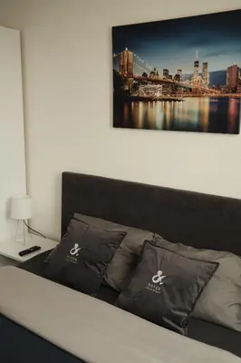 a bedroom with a bed with a picture on the wall at Apartman Silver in Jajce