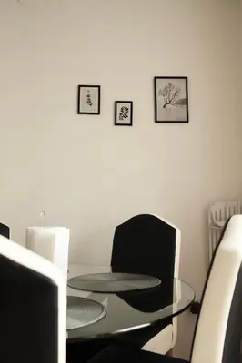 a dining room with a glass table and a chair at Apartman Silver in Jajce