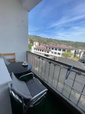 a balcony with a table and chairs on a building at Apartman Silver in Jajce