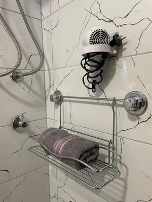 a shower with a towel on a shelf in a bathroom at Apartman Silver in Jajce