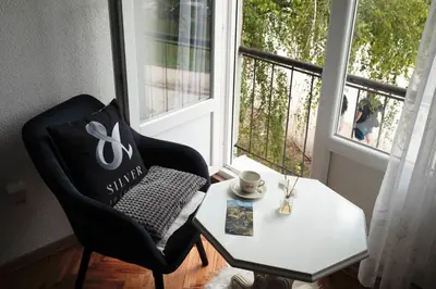 a room with a chair and a table and a window at Apartman Silver in Jajce