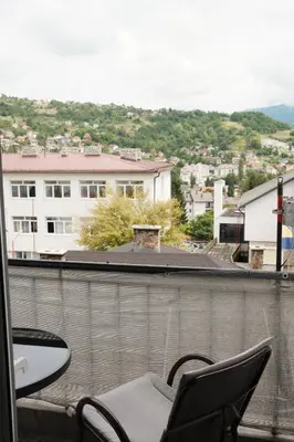 a balcony with chairs and a view of a city at Apartman Silver in Jajce