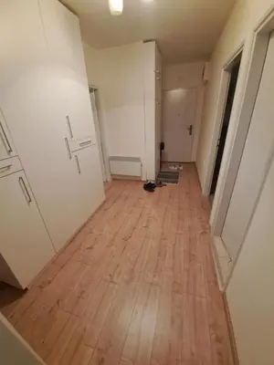 an empty room with a wooden floor and white walls at Stan na dan CentarM in Banja Luka