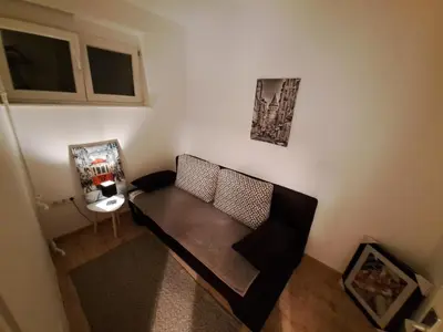 a small living room with a couch and a table at Stan na dan CentarM in Banja Luka