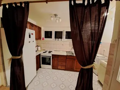 a kitchen with black curtains in a kitchen at Stan na dan CentarM in Banja Luka