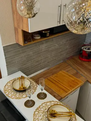 a table with two plates and wine glasses on it at Stan na dan sa dzakuzijem om relax in Prijedor