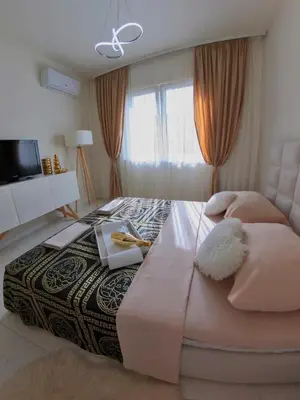 a bedroom with a large bed and a window at Stan na dan sa dzakuzijem om relax in Prijedor