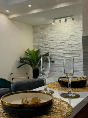 a table with two wine glasses on top of it at Stan na dan sa dzakuzijem om relax in Prijedor