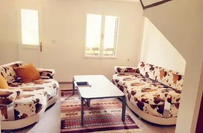 a living room with two couches and a table at Pine Oasis in Zavidovići