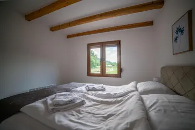 a white bed in a room with a window at Sweet Home Visoko FREE PARKING, AC, RENT A CAR in Visoko