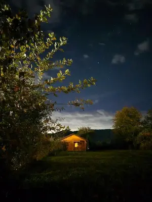 a lit up house in a field at night at Sweet Home Visoko FREE PARKING, AC, RENT A CAR in Visoko