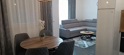 a living room with a table and a couch at Apartmani Sanja in Teslić