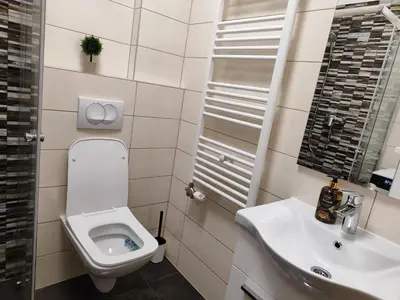 a bathroom with a toilet and a sink at Apartmani Sanja in Teslić
