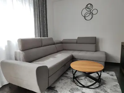 a living room with a couch and a table at Apartmani Sanja in Teslić