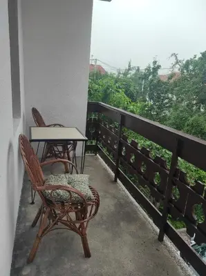 two chairs and a table on a balcony with a view at REA Home Visoko in Visoko