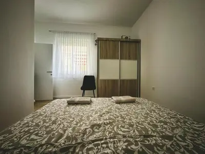 a bedroom with a bed with two pillows on it at Apartman Zdravko in Tomislavgrad