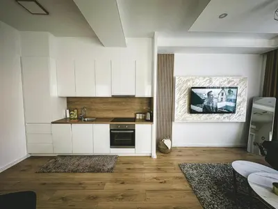 a kitchen with white cabinets and a sink at Apartman Zdravko in Tomislavgrad